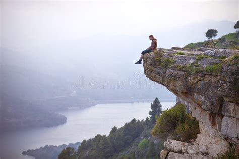 205 Young Man Sitting On Edge Of Cliff Stock Photos High Res Pictures