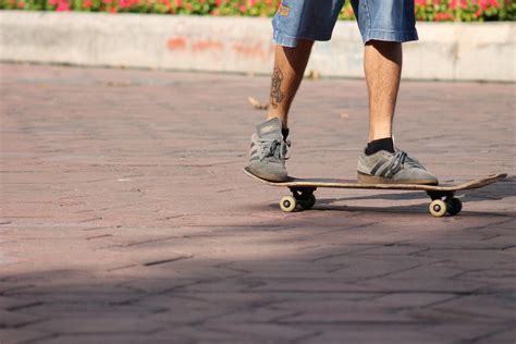 A Blurry Photo Of A Person On A Skateboard In Front Of Some People