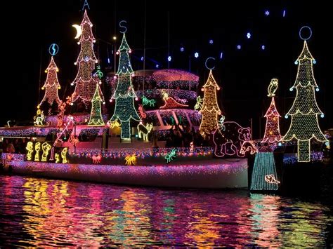 A Boat Decorated With Christmas Lights On The Water