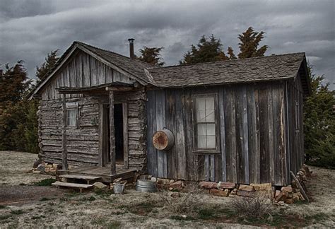 A Small Wooden Shack Sitting On Top Of The Ocean