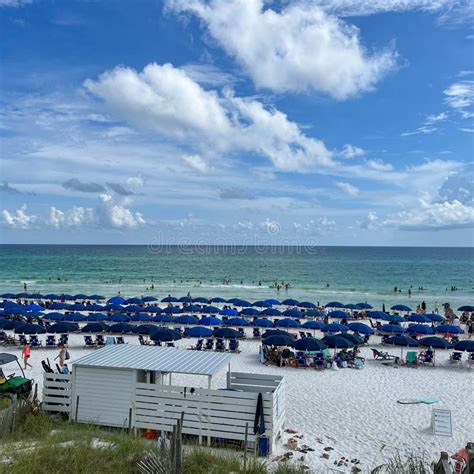 An Aerial View Of A Beach With Blue Umbrellas And The Words Florida 10