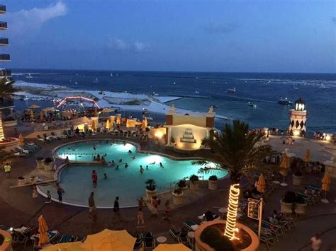 Beautiful Evening Shot Of The Pool Deck At Emerald Grande And The View Of Destin Harbor Beyond