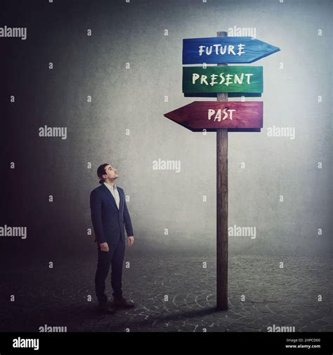 Businessman Stands In Front Of A Signpost Showing Three Different