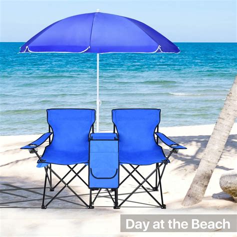 Chairs And Tables On The Beach With Umbrellas