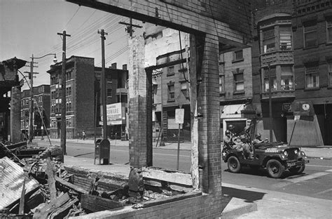 Cleveland 1966 A Car Of National Guardsmen Passes A Burned Out Store