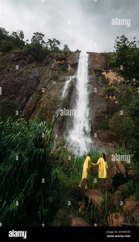 Couple In Love At The Waterfall Boy And Girl At The Falls Man And Woman In Yellow Raincoats