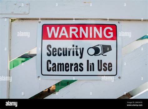 Destin Florida Sign With Warning Security Cameras In Use On A Wooden