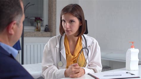 Doctor Recommending To Patient Doctor Giving Advice To Patient In