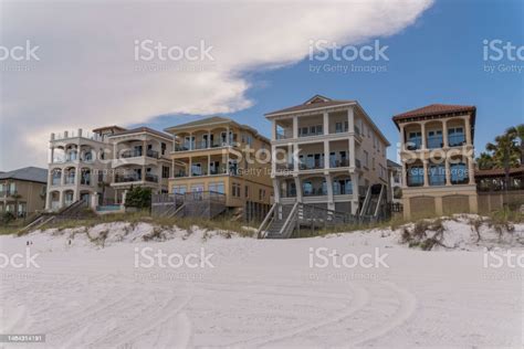 Facade Of Houses With Footbridge Access To The White Sand Beach In