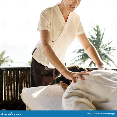 Front View Of Professional Massage Therapist Giving Massage On Woman