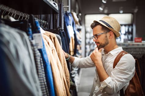 Handsome Man Shopping For New Clothes In Store Alldaychic