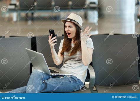 Irritated Dissatisfied Traveler Tourist Woman With Laptop Hold Mobile