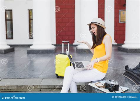 Irritated Traveler Tourist Woman With Suitcase Sit On Stairs Using