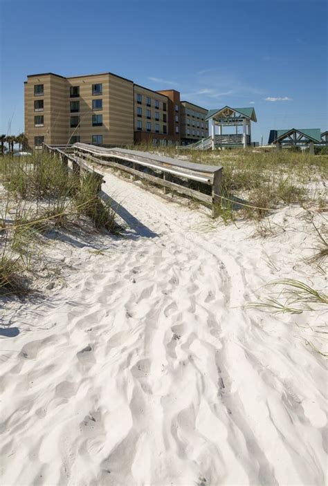 Path On Sand Heading To A Boardwalk In The Middle Of Sand Dunes At The Front Of Hotel Destin