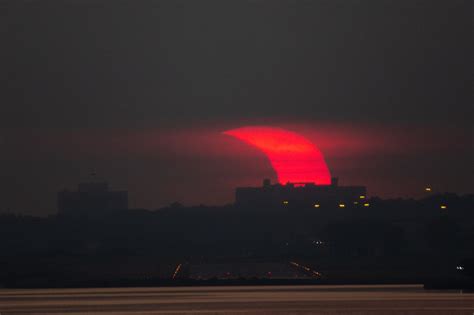 See Stunning Partial Solar Eclipse As Sun Rises Over Lake Erie In