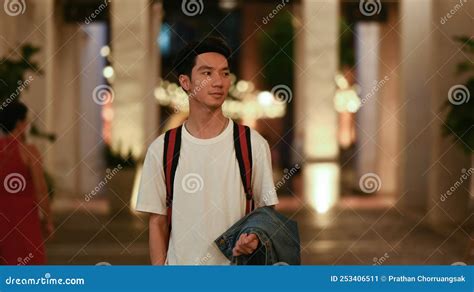 Shot Of Handsome Young Asian Man Traveler Walking Through Night City