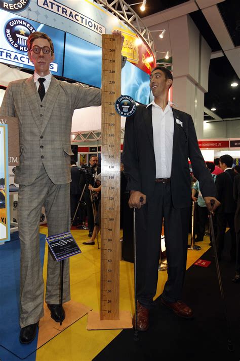 Two Tallest Men In The World Standing Next To A 6 0 Tall Guy R Tall