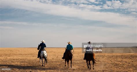 Utah Cowboys In Distance Riding With Stetson Shirt And Using Lasso High