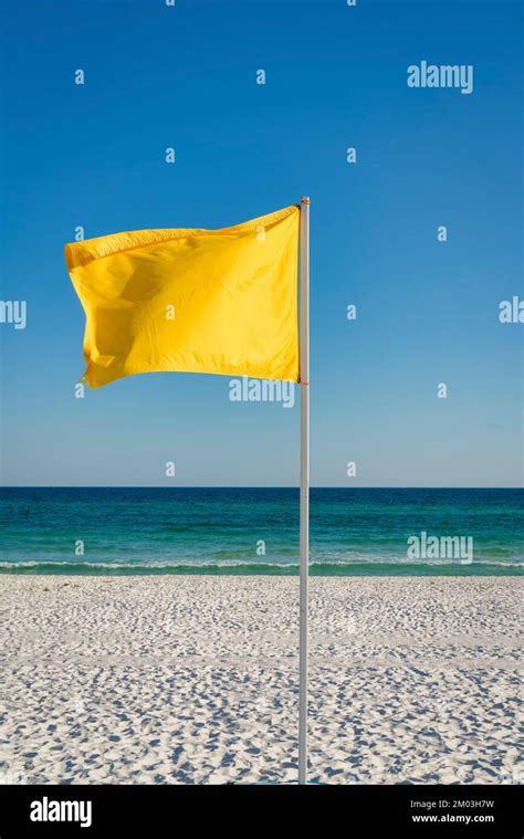 Yellow Flag On A Pole At The Beach In Destin Florida Vertical Shot Of